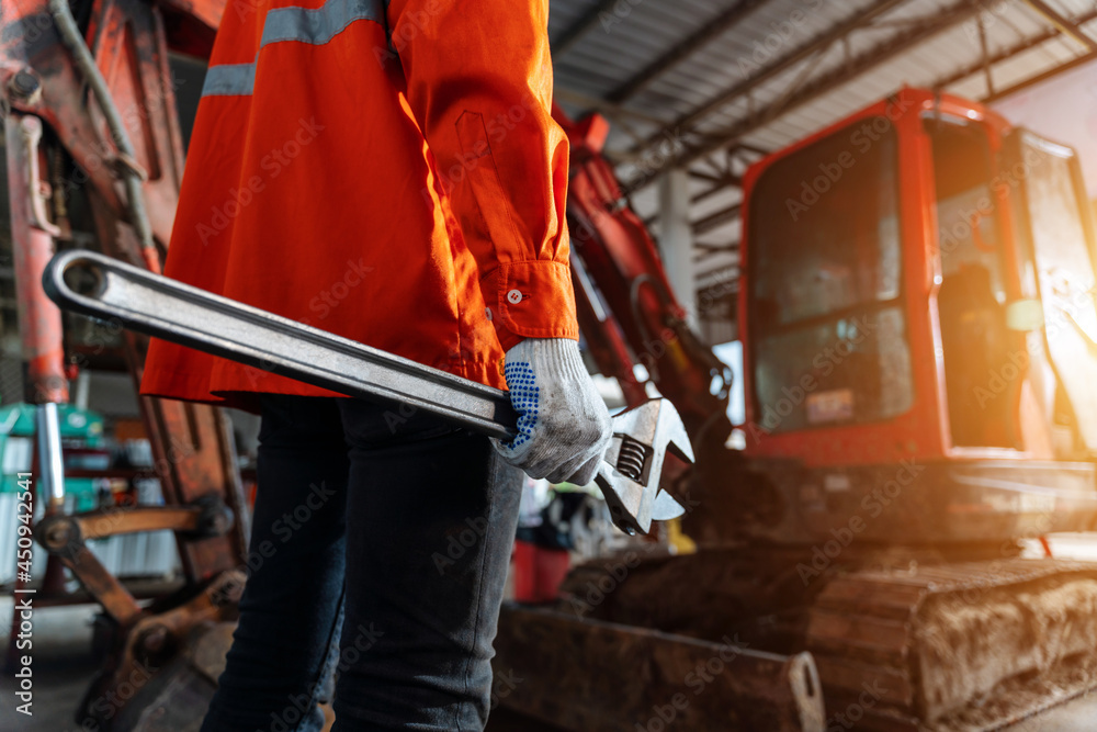 Close up of a human hand holding a tool for maintenance or excavator at maintenance center, Heavy Du