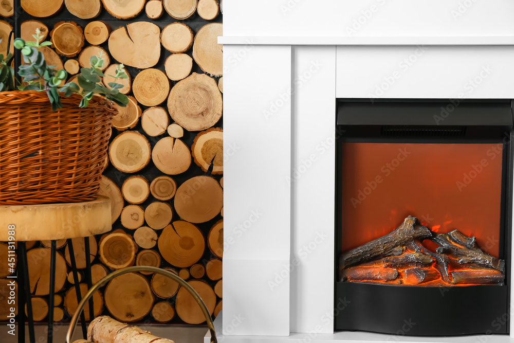 Modern fireplace near wooden wall