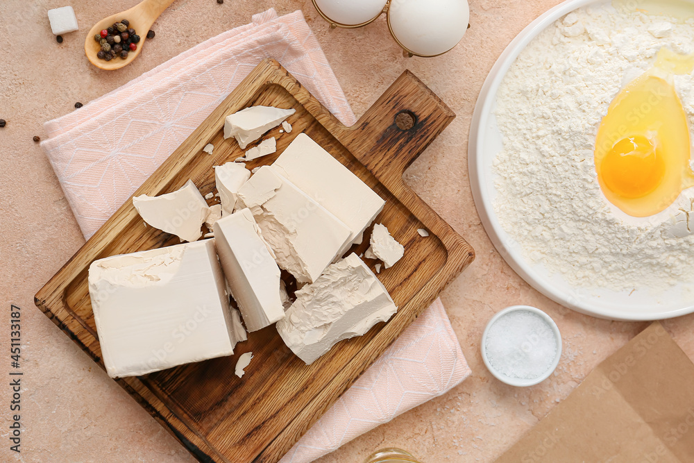 Composition with fresh yeast briquettes on light background