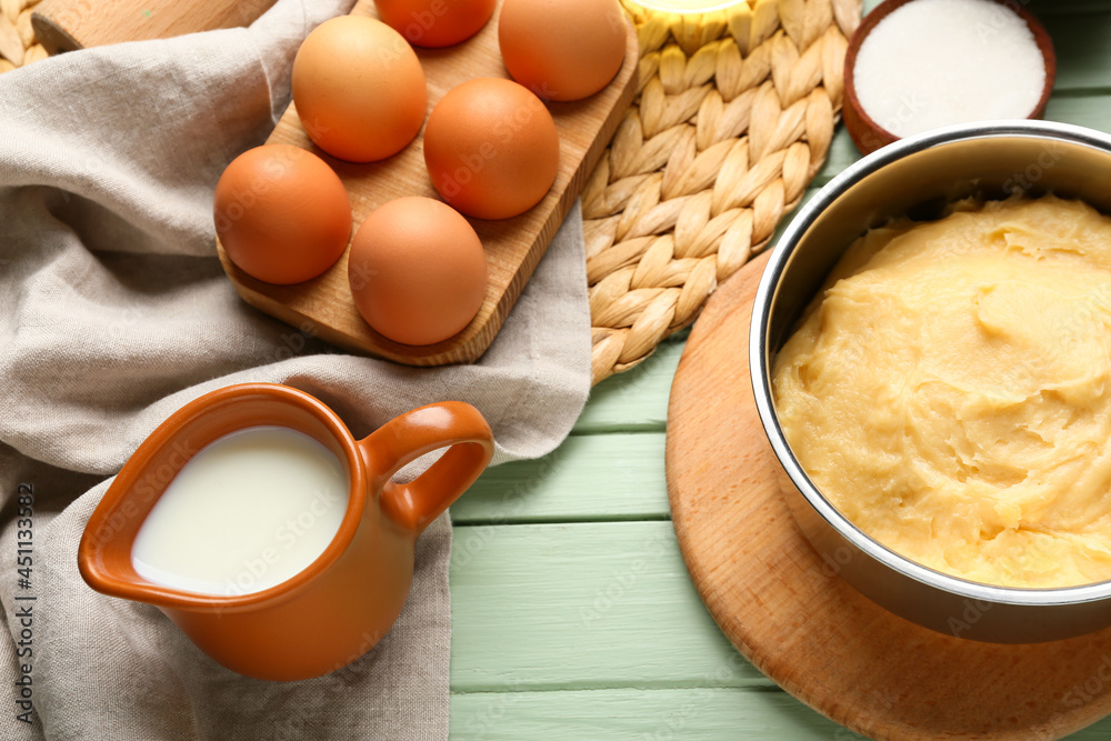 Ingredients for preparing churros on color wooden background