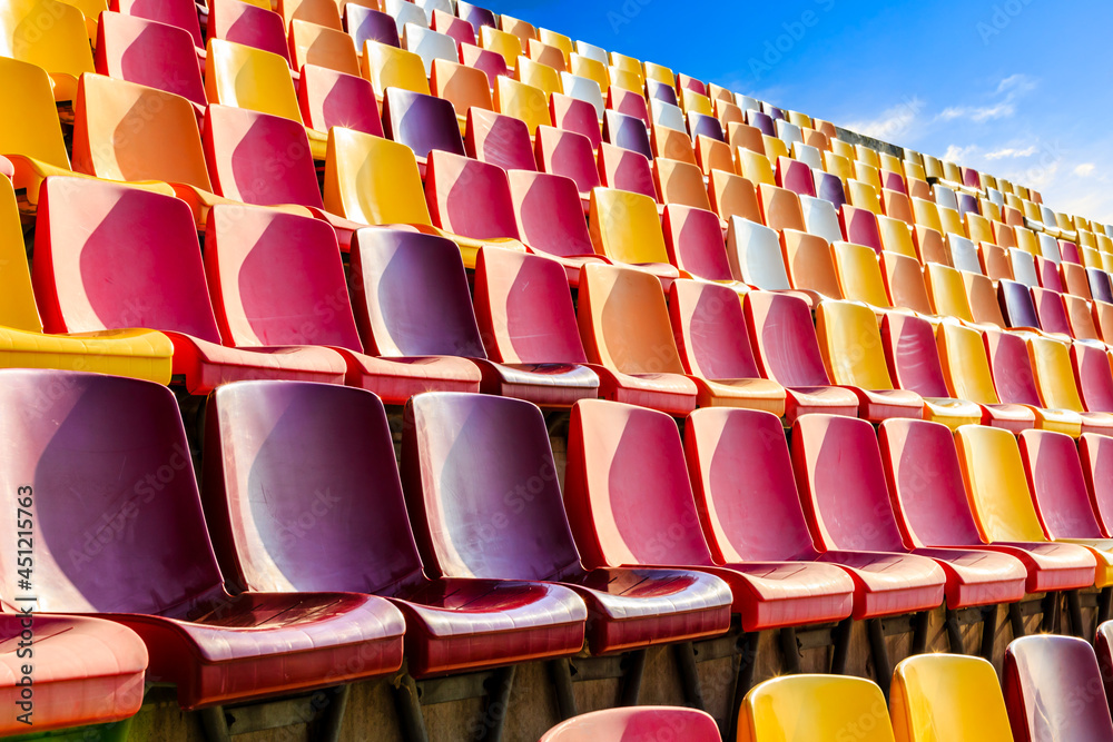 Empty plastic chairs in the stadium.