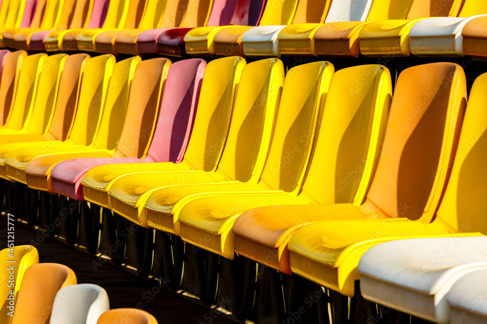 Empty plastic chairs in the stadium.