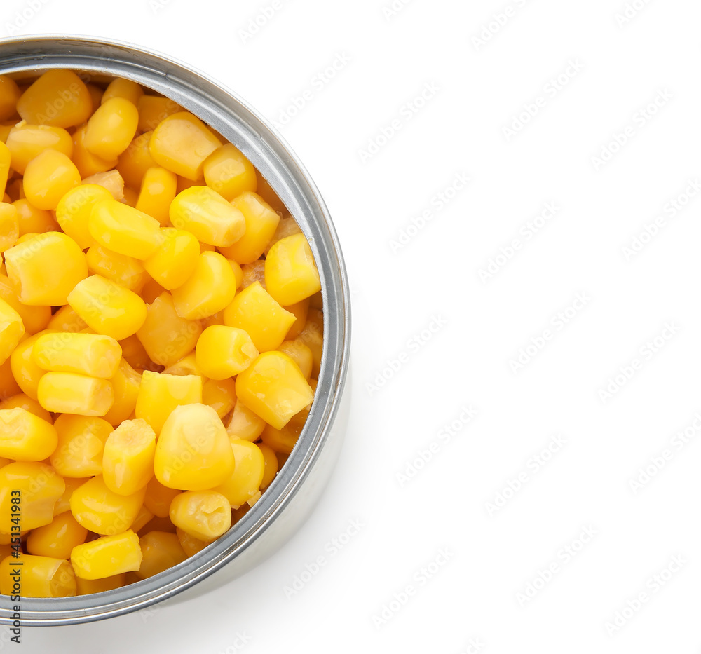 Opened tin can of corn kernels on white background