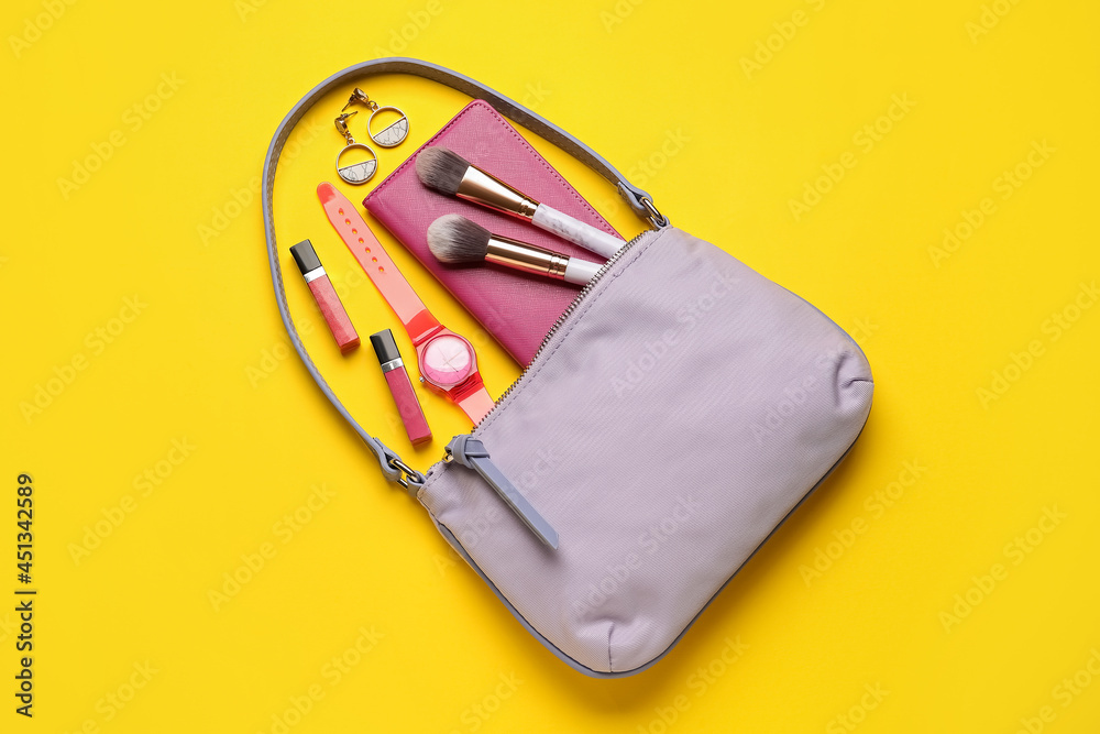 Composition with stylish handbag and different accessories on color background