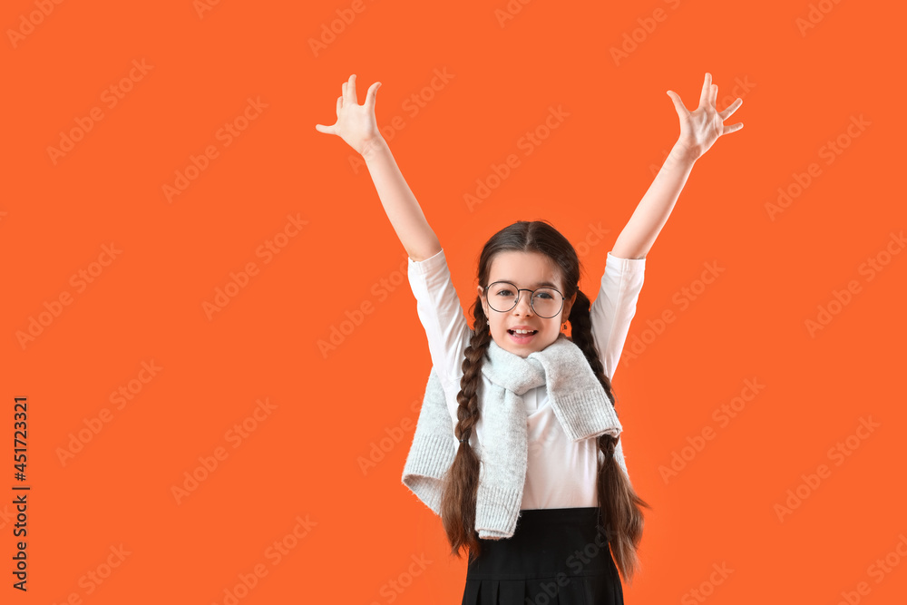 Happy little school girl on color background