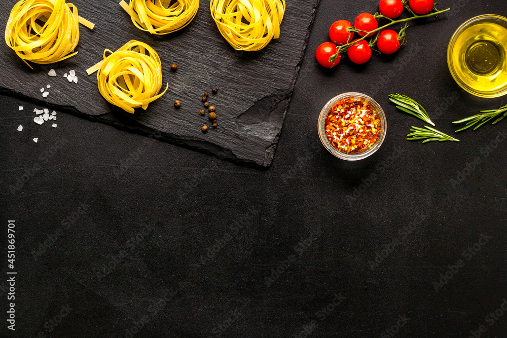 Flat lay of pasta ingredients with tomatoes olive oil spices