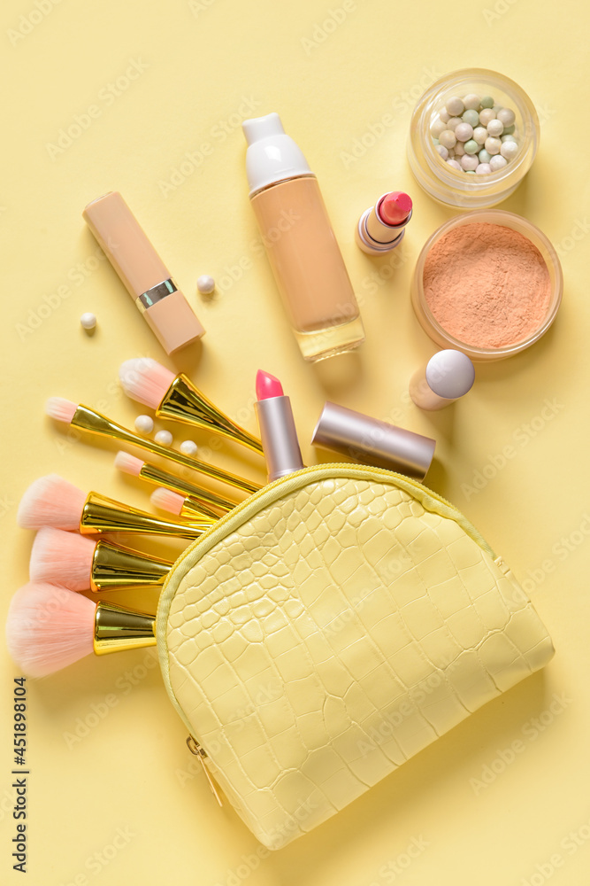 Stylish bag and decorative cosmetics on color background