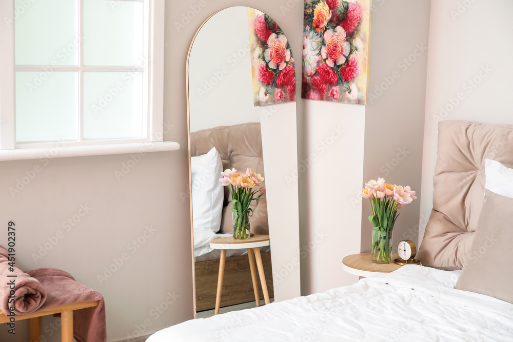 Stylish mirror in interior of bedroom