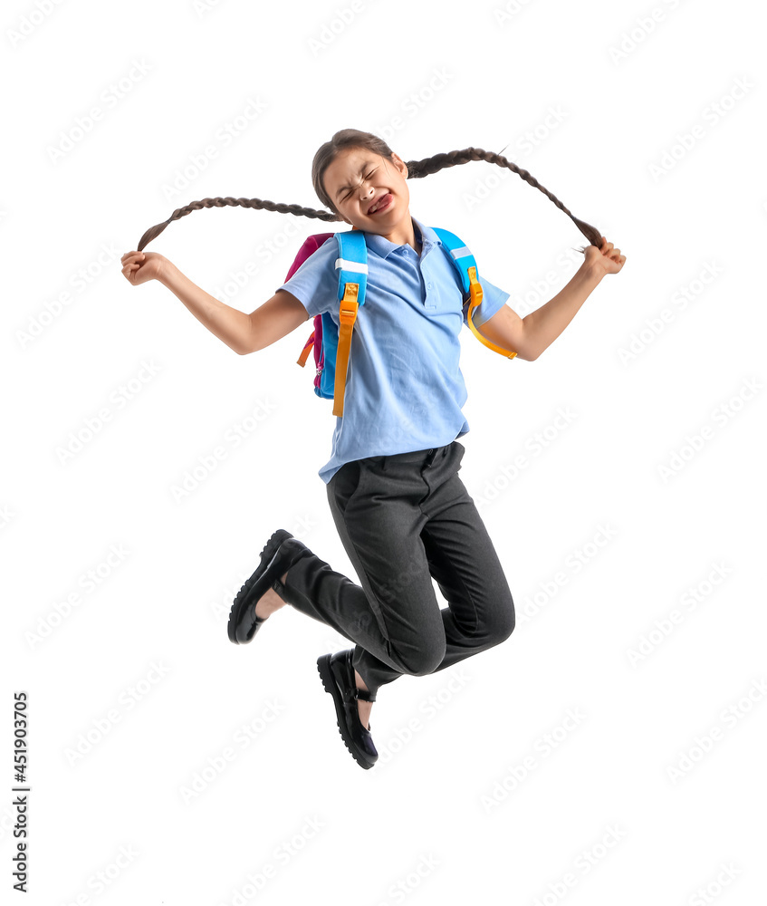 Jumping little schoolgirl on white background