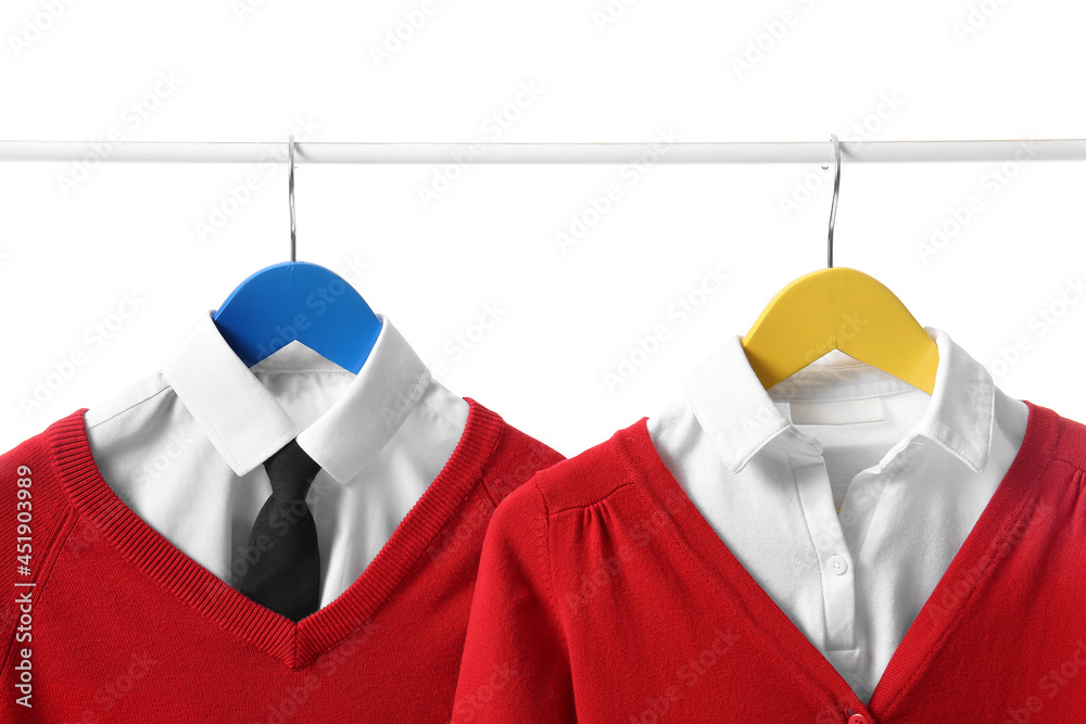 Rack with stylish school uniform on white background