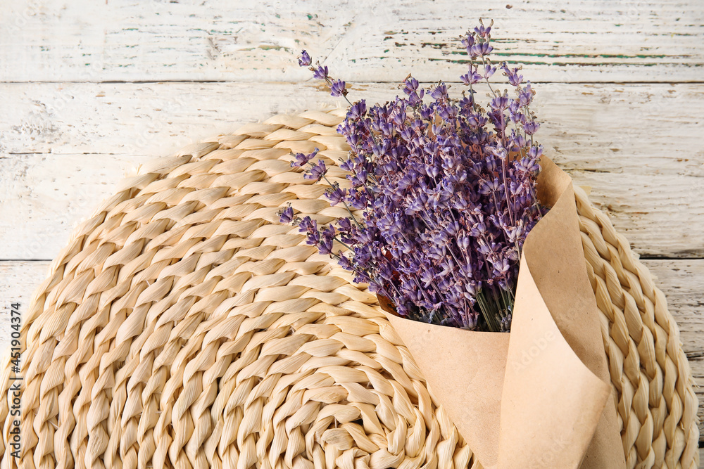 Bouquet of lavender flowers on light wooden background, closeup