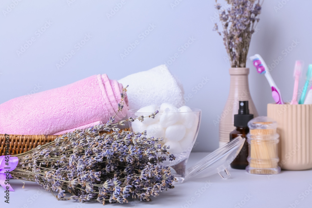 Composition with bath supplies and lavender flowers on color background