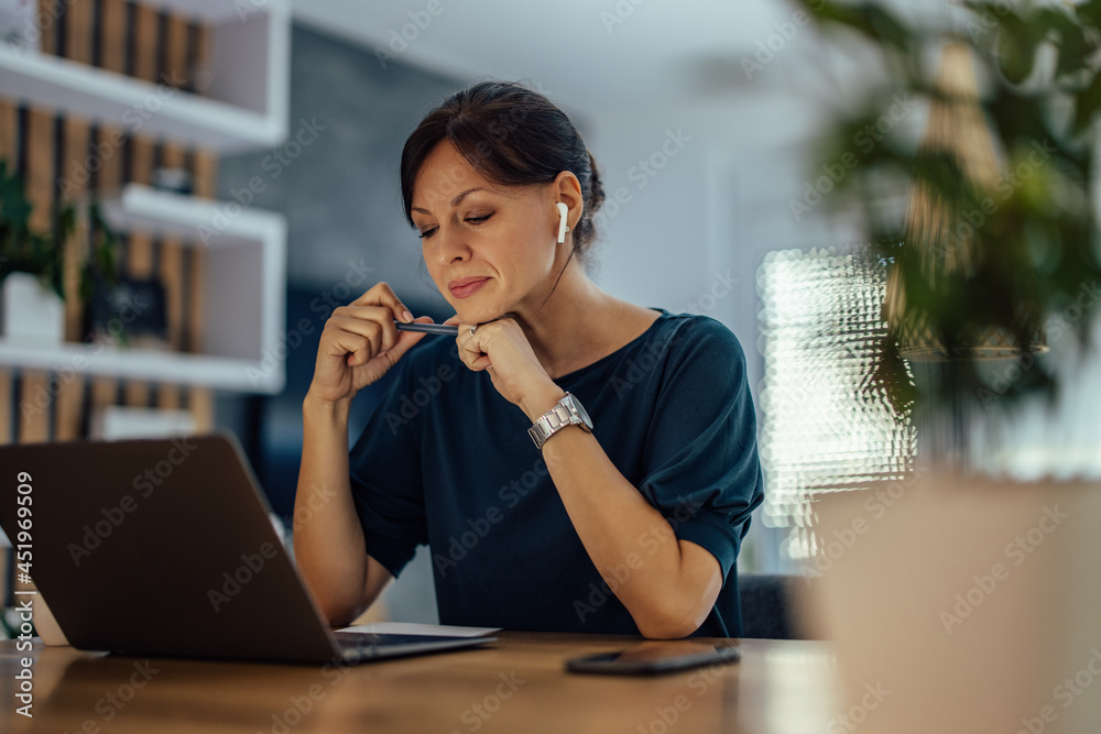 Stressed woman working on solving business problem, at home.