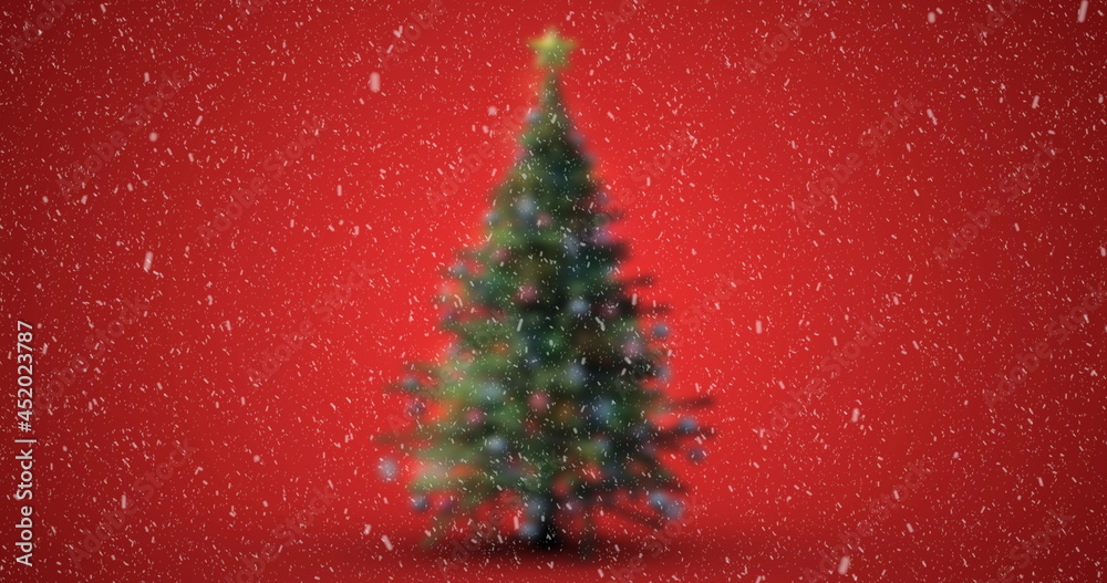 Image of christmas tree with snow falling on red background