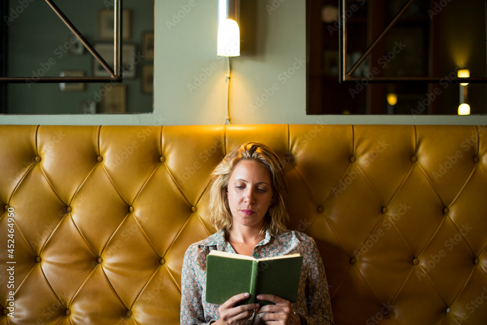 Blond woman reading a book