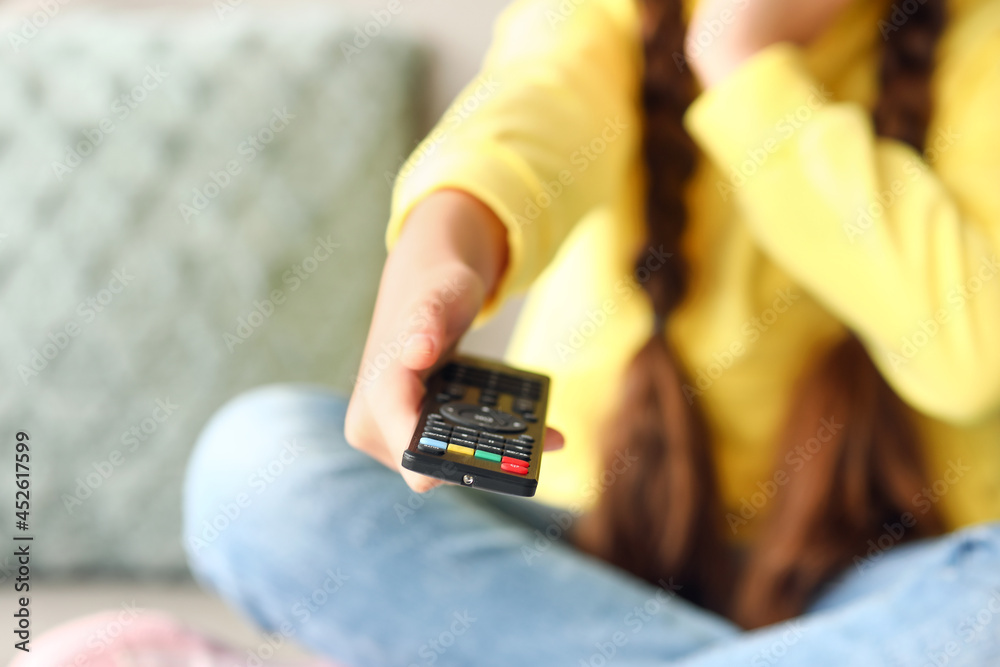 Cute girl watching cartoons at home, closeup