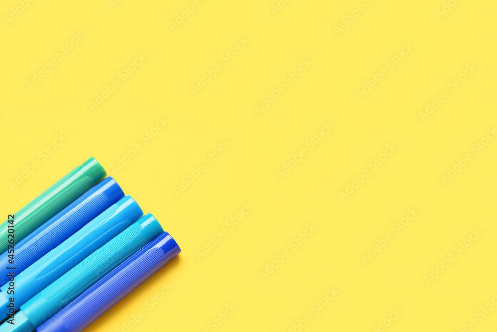 Colorful markers on color background