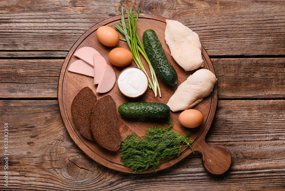 Board with ingredients for okroshka on wooden background