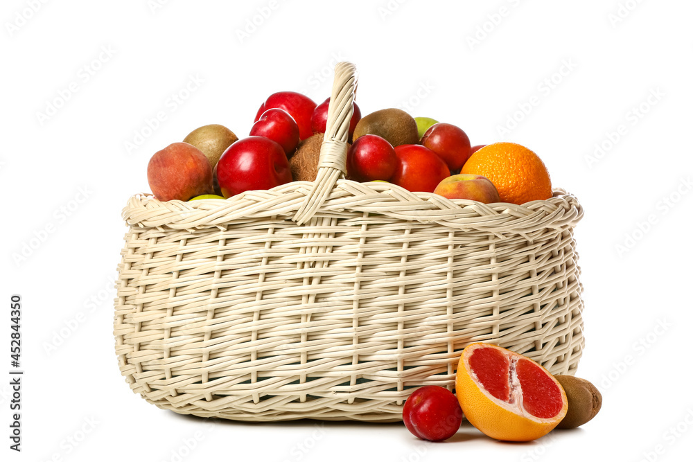 Basket with fresh fruits on white background