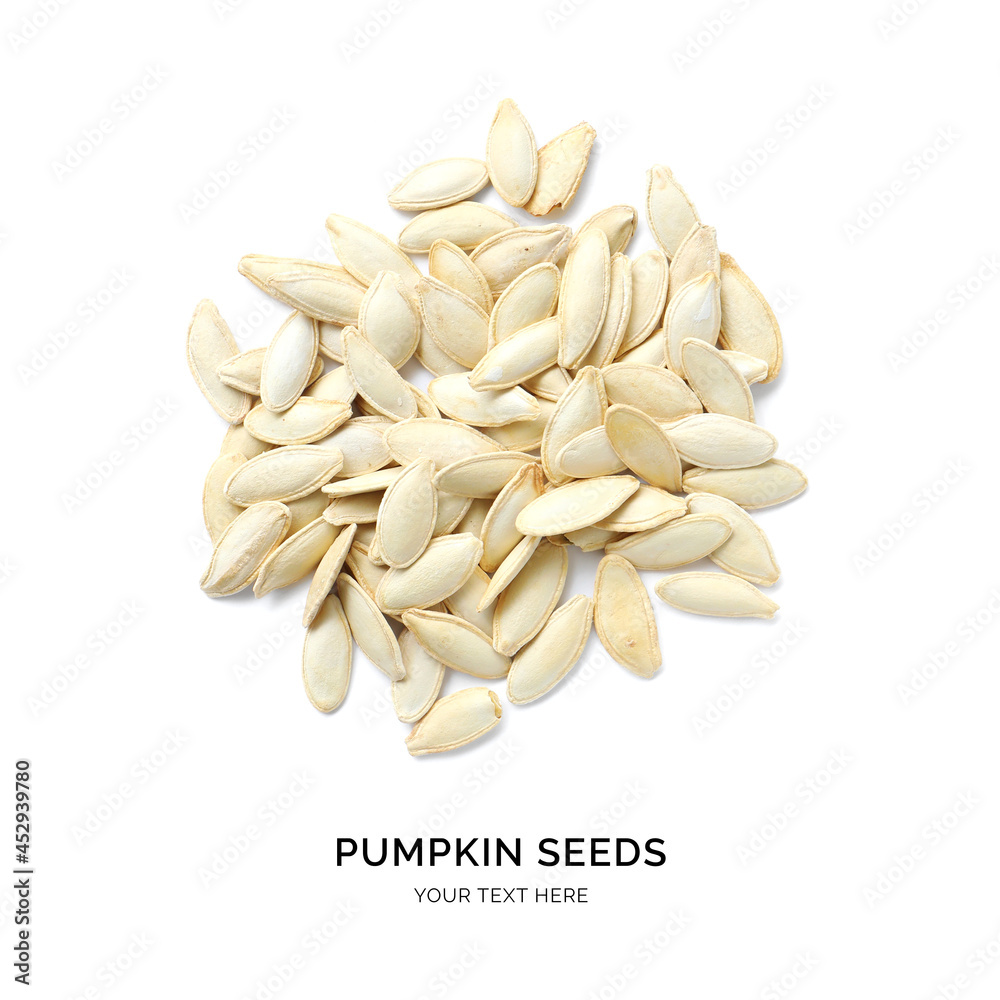 Creative layout made of pumpkin seeds on the white background. Flat lay. Food concept. Macro  concep