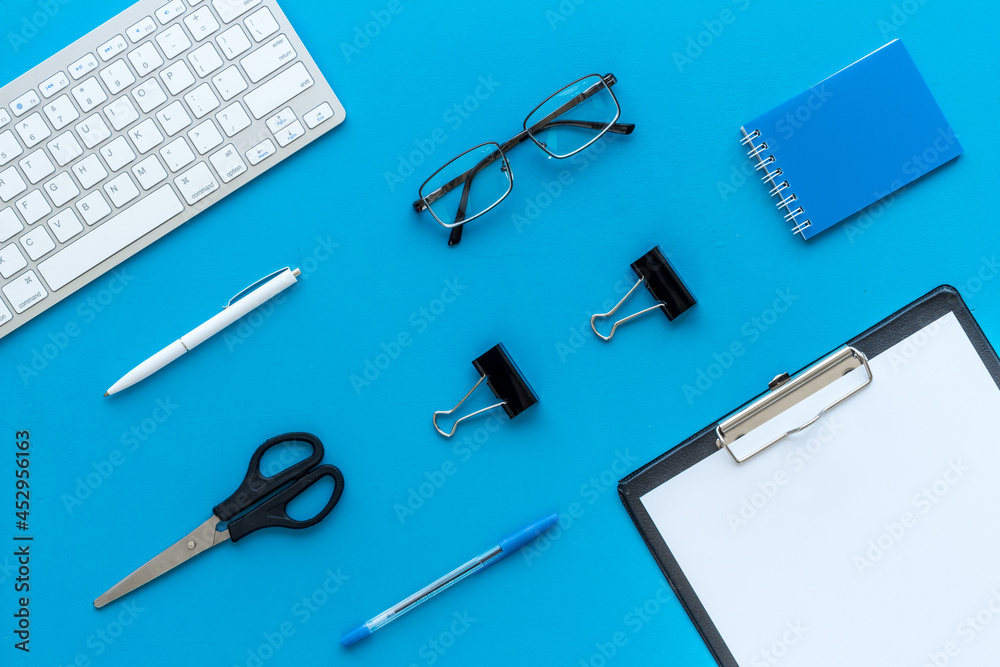 Top view of working place with computer keyboard and notepad