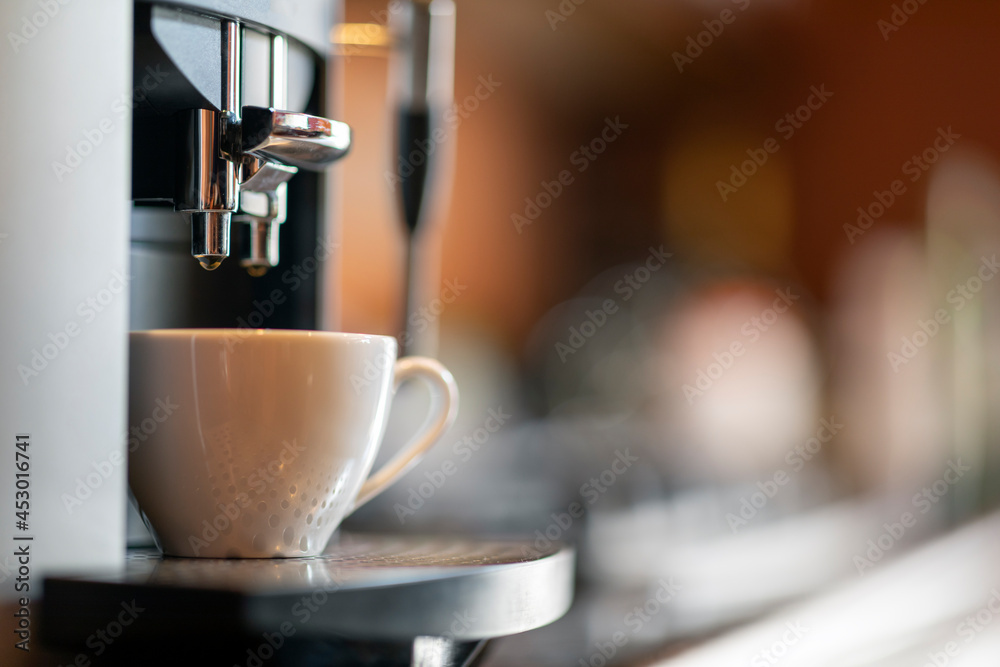 Coffee cup on espresso machine, making coffee