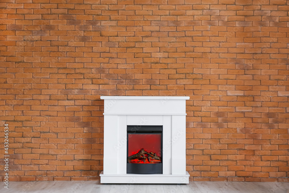 Modern fireplace near brick wall