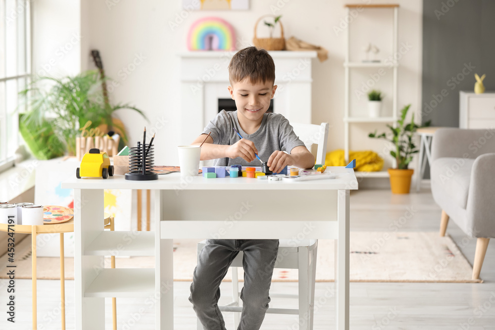 Little boy painting at home