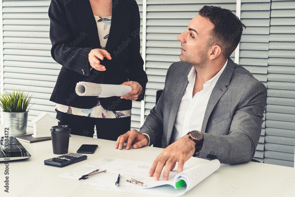 Businessman executive checking work while meeting discussion with businesswoman worker in modern wor