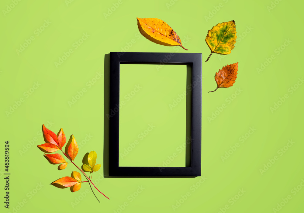 Autumn leaves with blank photo frame