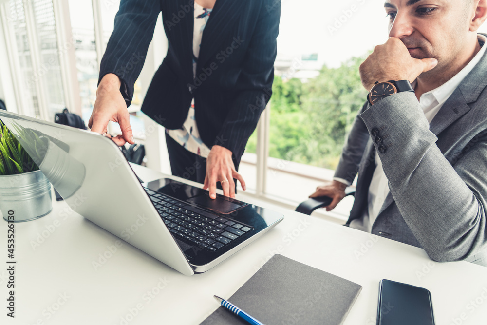 Businessman executive is in meeting discussion with a businesswoman worker in modern workplace offic