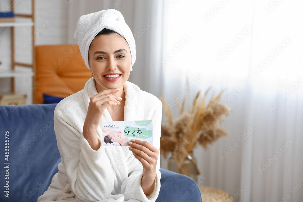 Young woman with gift certificate for massage at home