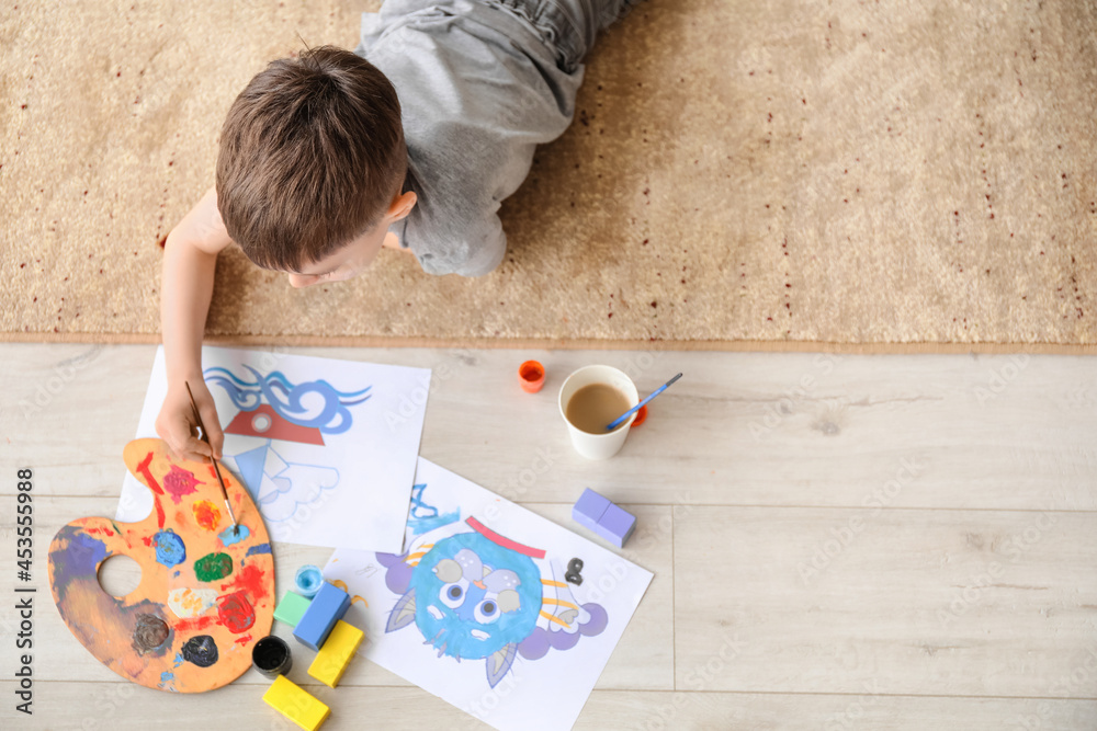 Little boy painting at home