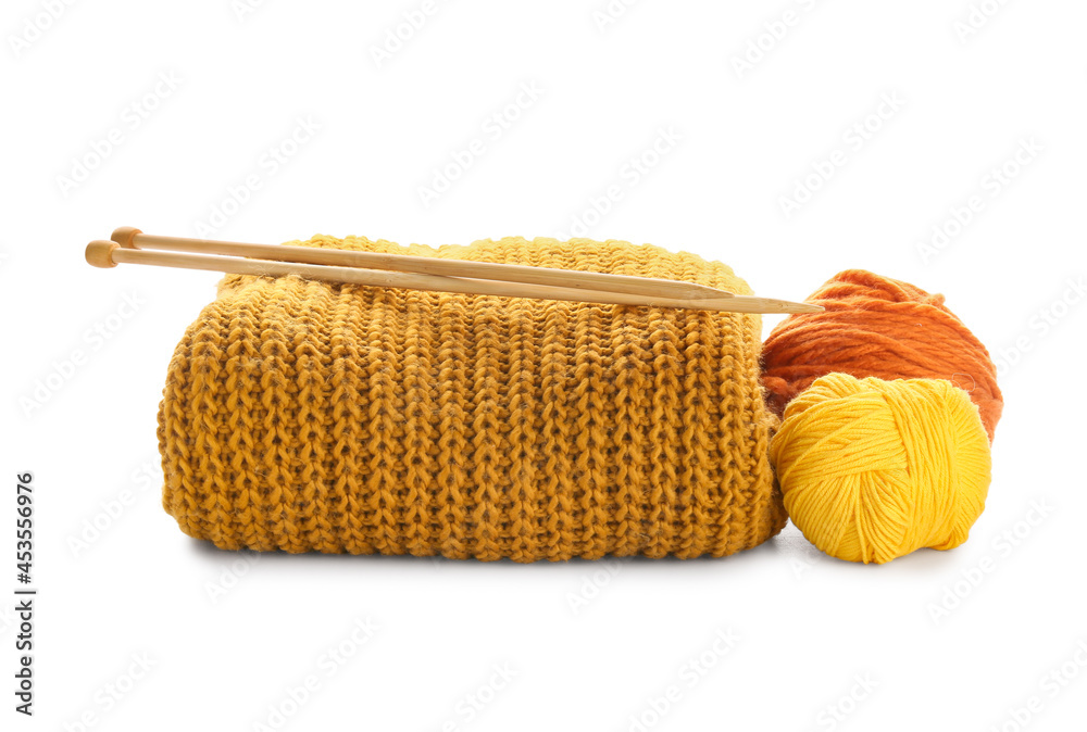 Yarn with knitting needles and plaid on white background