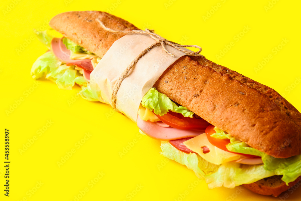 Tasty ciabatta sandwich on color background, closeup