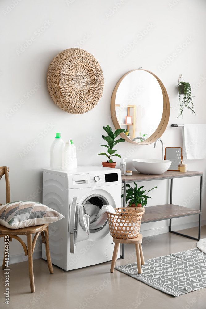 Interior of bathroom with modern washing machine