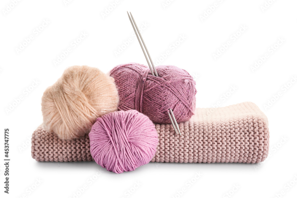 Yarn with knitting needles and plaid on white background