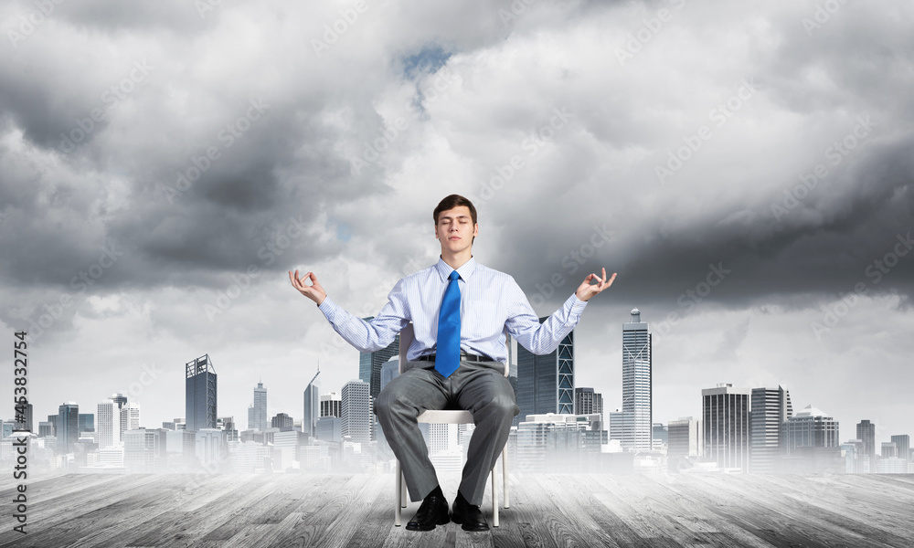 businessman meditates on office chair