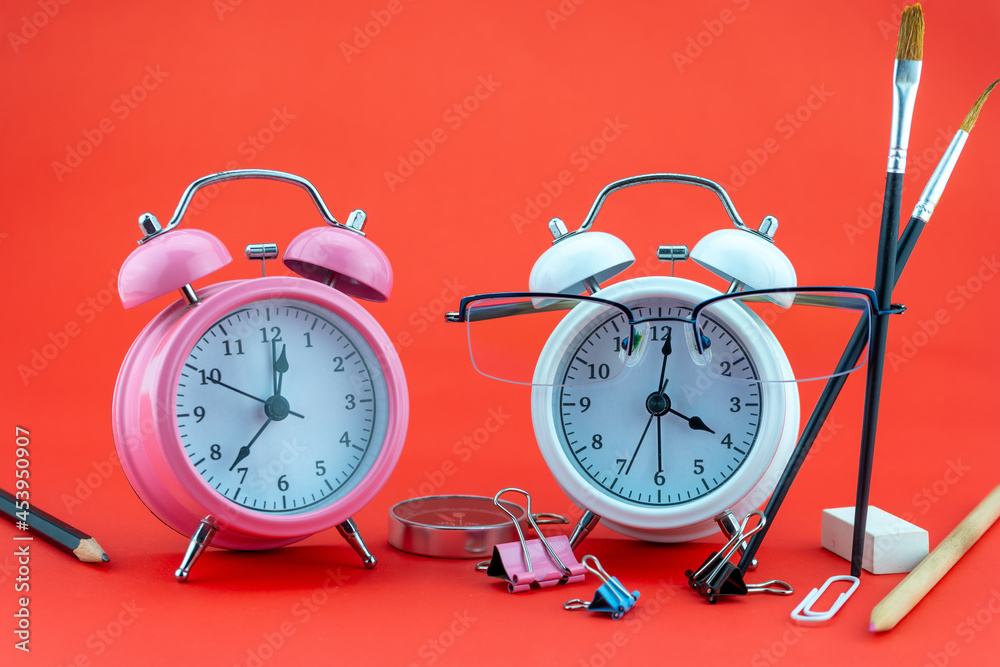 Concept Education or business Alarm clock and teacher glasses Business objects isolated on colorful 