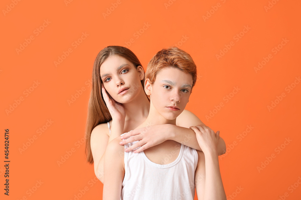 Teenagers with dyed eyebrows on color background