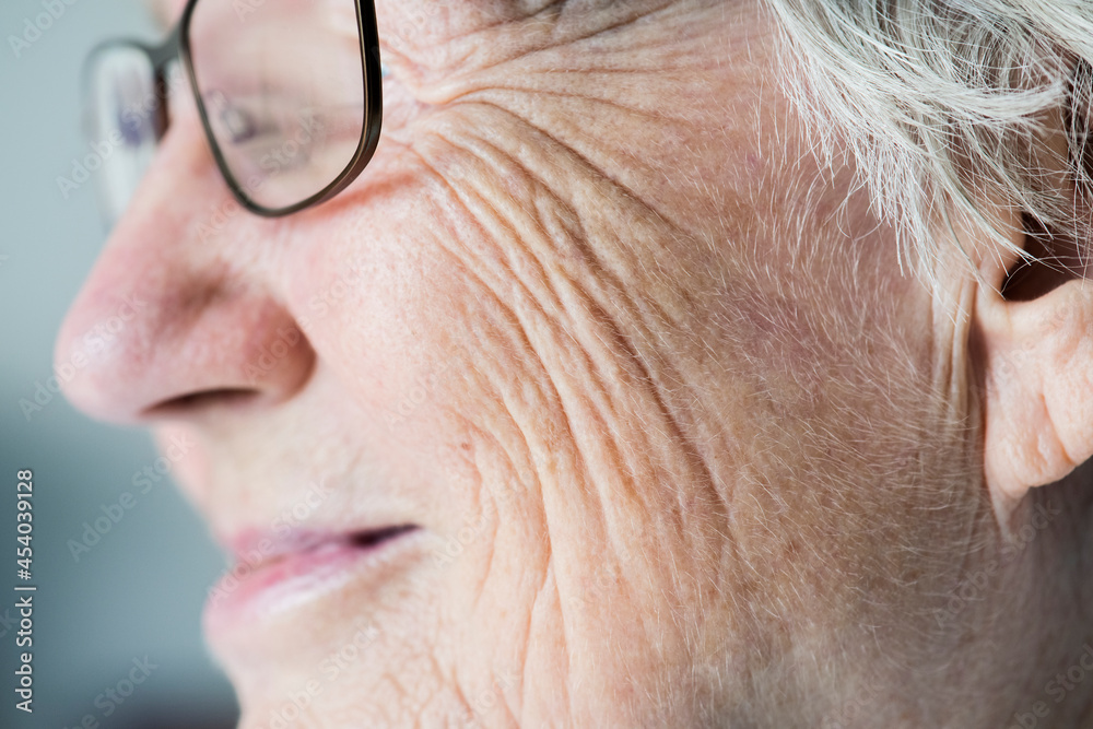 Side closeup portrait of white elderly woman