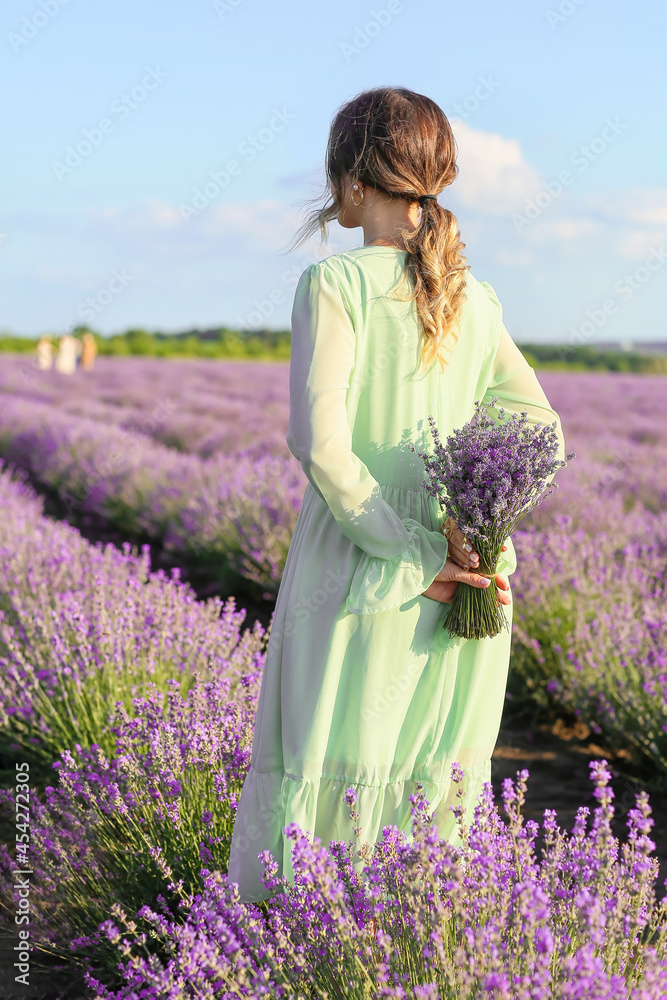 Beautiful young woman in lavender field