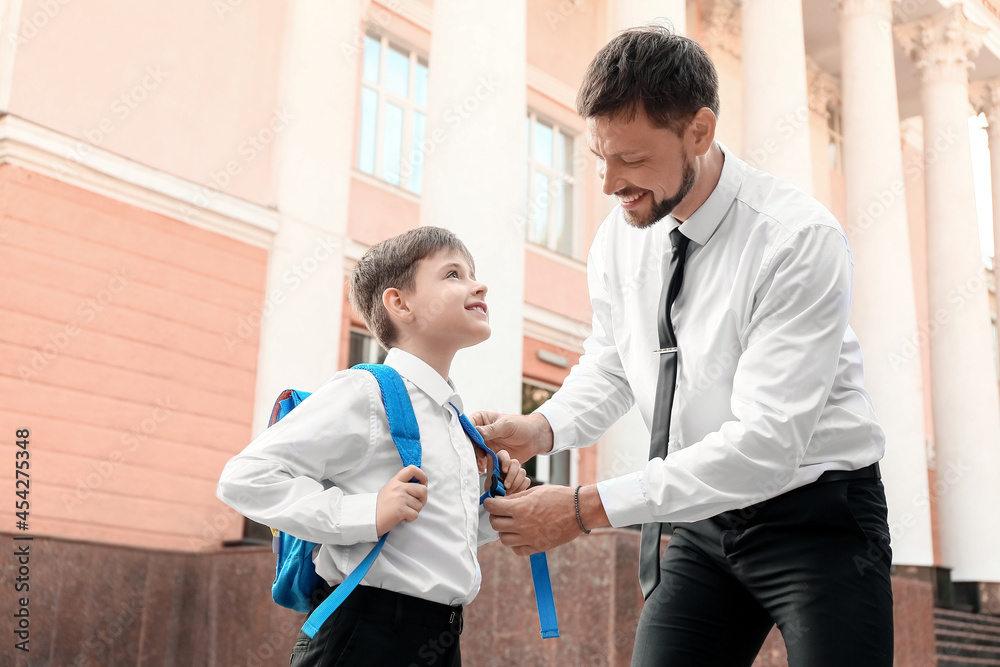 Cute little boy going to school with his father