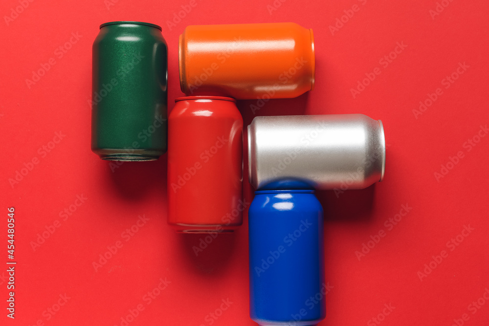 Cans of soda on color background