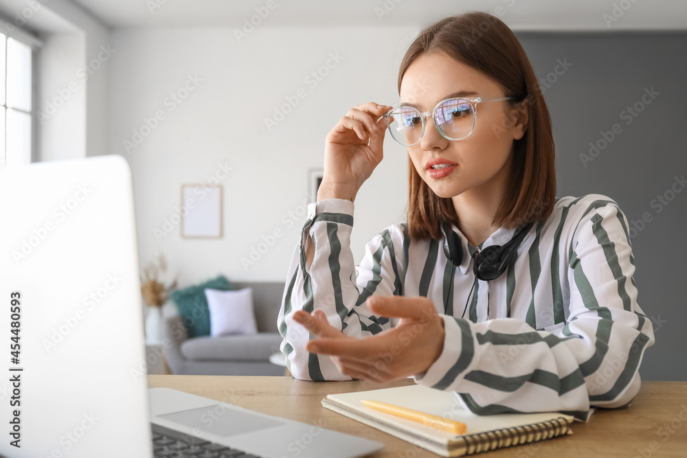 Young woman with laptop at home