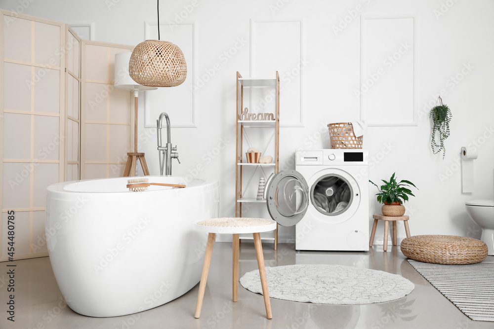 Interior of bathroom with modern washing machine