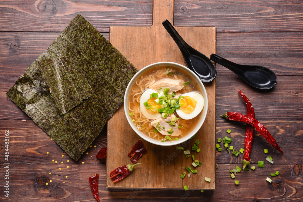 Composition with tasty Chinese soup on wooden background