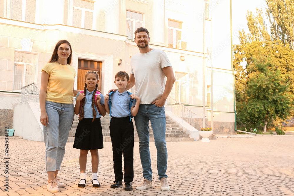 Cute little children going to school with their parents