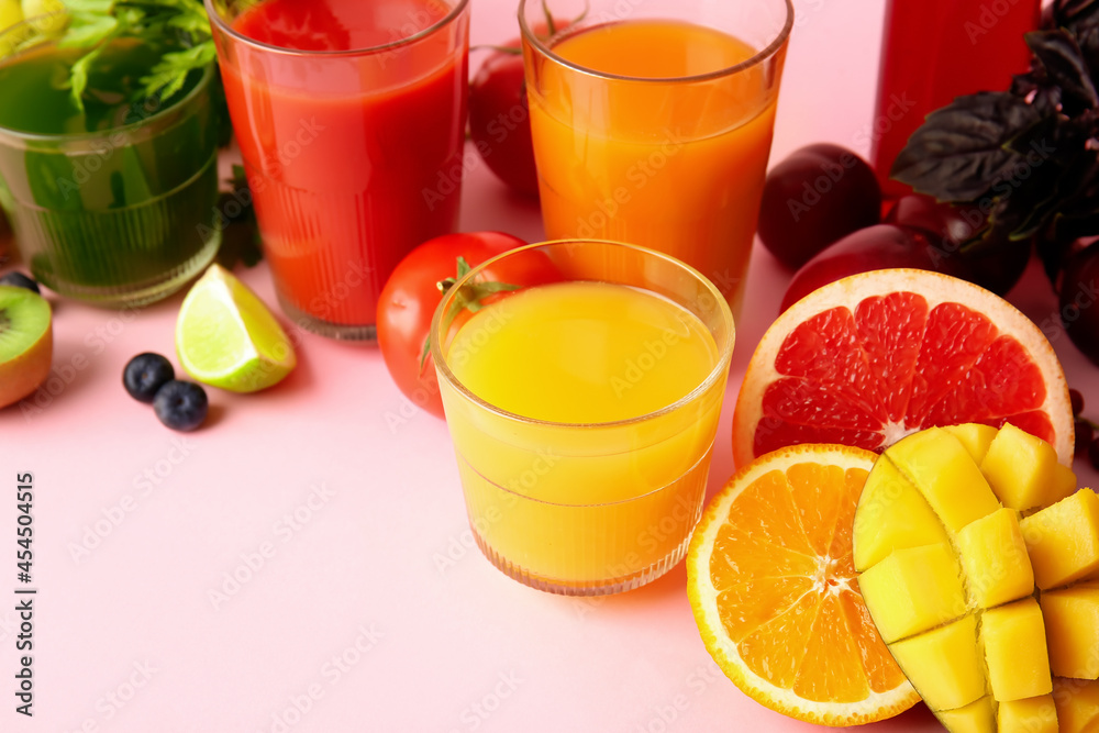 Glasses with healthy juice, fruits and vegetables on color background