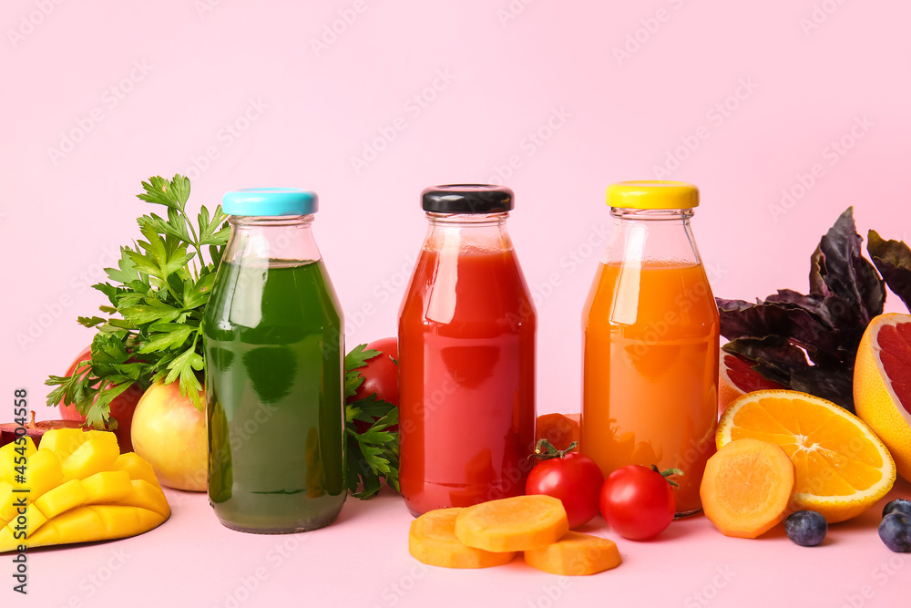 Bottles with healthy juice, fruits and vegetables on color background